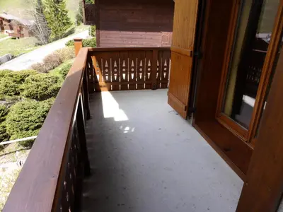 a wooden porch with a bench next to a door at Résidence Floralie - Domaine Des Lapons 2 - Lapons 2 Floralie 6 MAE-5337 in Les Contamines-Montjoie
