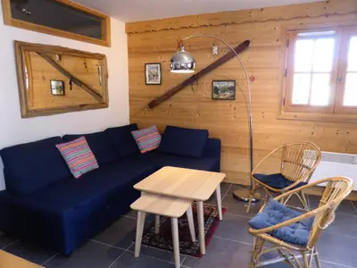 a living room with a blue couch and a table at Résidence Cressoua - Cressoua A11 MAE-5338 in Les Contamines-Montjoie