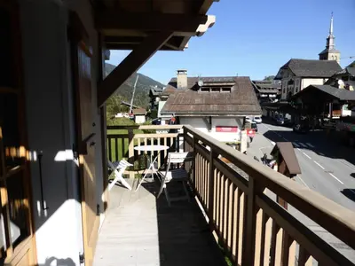 a balcony of a house with a table and chairs at Résidence Cressoua - Cressoua A11 MAE-5338 in Les Contamines-Montjoie