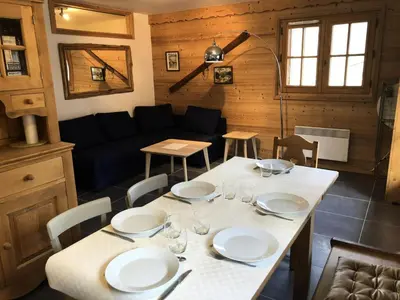 a dining room with a table and a couch at Résidence Cressoua - Cressoua A11 MAE-5338 in Les Contamines-Montjoie