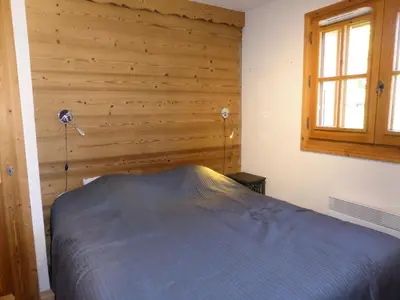 a bedroom with a bed and a wooden wall at Résidence Cressoua - Cressoua A11 MAE-5338 in Les Contamines-Montjoie
