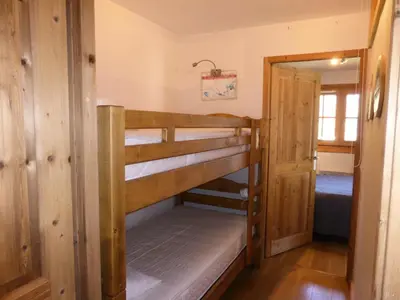 a room with two bunk beds and a doorway at Résidence Cressoua - Cressoua A11 MAE-5338 in Les Contamines-Montjoie