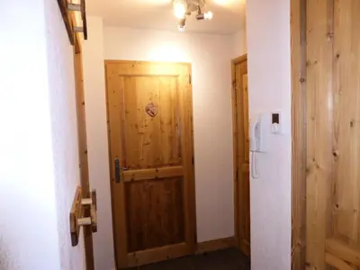 a hallway with a wooden door in a room at Résidence Cressoua - Cressoua A11 MAE-5338 in Les Contamines-Montjoie