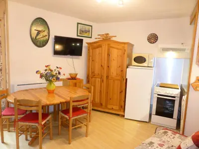 a kitchen and dining room with a table and a refrigerator at Résidence Pierres Blanches - Pierres Blanches H579 MAE-5342 in Les Contamines-Montjoie