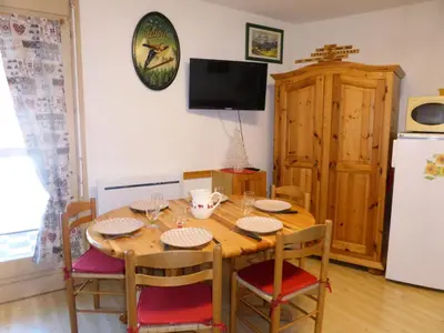 a dining room table with chairs and a refrigerator at Résidence Pierres Blanches - Pierres Blanches H579 MAE-5342 in Les Contamines-Montjoie