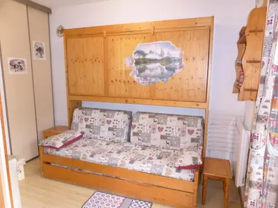 a bedroom with a bed with a wooden headboard at Résidence Pierres Blanches - Pierres Blanches H579 MAE-5342 in Les Contamines-Montjoie