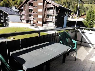 a balcony with a table and chairs and a building at Résidence Rochasset - Rochasset D75 MAE-5345 in Les Contamines-Montjoie