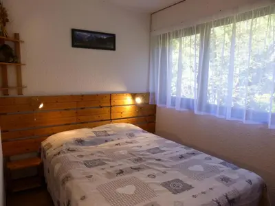 a bedroom with a bed and a window at Résidence Rochasset - Rochasset D75 MAE-5345 in Les Contamines-Montjoie
