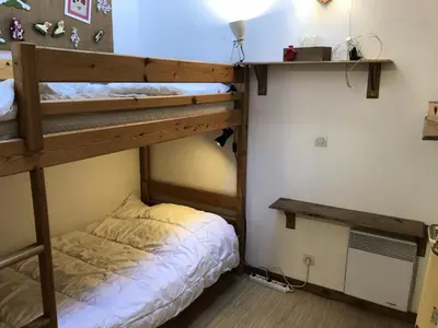 a bedroom with two bunk beds and a desk at Résidence Les Cimes D'or A - Cimes d'Or A337 MAE-5349 in Les Contamines-Montjoie
