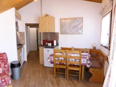 a kitchen with a table and chairs in a room at Résidence Combettes - Combettes E308 MAE-5352 in Les Contamines-Montjoie