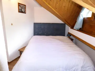 a small bedroom with a white bed in a attic at Résidence Combettes - Combettes E308 MAE-5352 in Les Contamines-Montjoie
