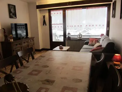 a living room with a couch and a tv at Résidence Bionnassay - Bionnassay B159 MAE-5357 in Les Contamines-Montjoie