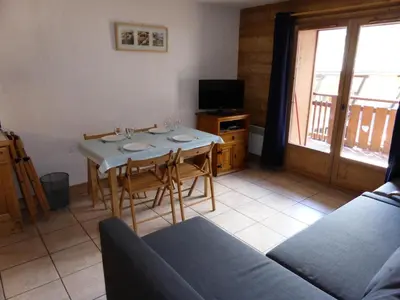 a living room with a table with chairs and a couch at Résidence Chamois - Chamois 22 MAE-5363 in Les Contamines-Montjoie