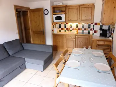 a living room with a table and a couch at Résidence Chamois - Chamois 22 MAE-5363 in Les Contamines-Montjoie