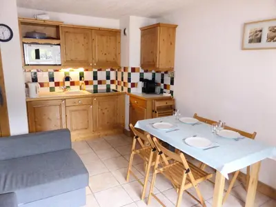 a kitchen with a table and chairs in a room at Résidence Chamois - Chamois 22 MAE-5363 in Les Contamines-Montjoie