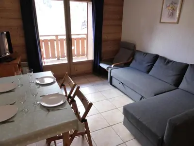 a living room with a table and a couch at Résidence Chamois - Chamois 22 MAE-5363 in Les Contamines-Montjoie