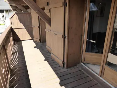 a row of wooden doors on a porch at Résidence Chamois - Chamois 22 MAE-5363 in Les Contamines-Montjoie