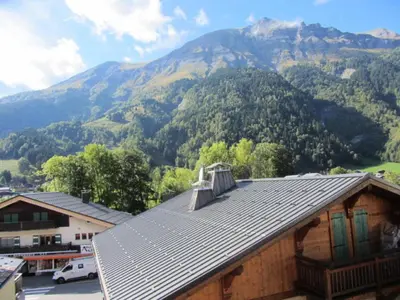 a roof of a house with mountains in the background at Résidence Chamois - Chamois 22 MAE-5363 in Les Contamines-Montjoie
