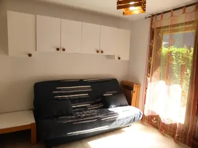 a black couch in a room with a window at Résidence Borgia - Borgia A3 MAE-5367 in Les Contamines-Montjoie