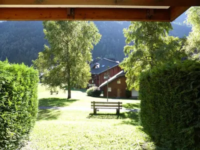 a park with a bench and trees and a building at Résidence Borgia - Borgia A3 MAE-5367 in Les Contamines-Montjoie