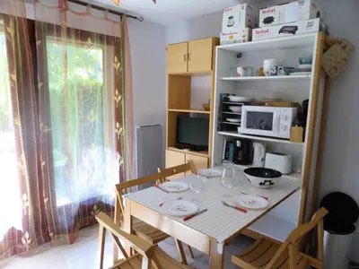 a kitchen with a table with chairs and a microwave at Résidence Borgia - Borgia A3 MAE-5367 in Les Contamines-Montjoie