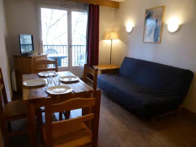 a living room with a blue couch and a table at Résidence Le Grand Panorama - Grand Panorama 115 MAE-5286 in Saint-Gervais-les-Bains