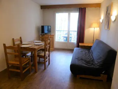 a living room with a dining room table and a couch at Résidence Le Grand Panorama - Grand Panorama 115 MAE-5286 in Saint-Gervais-les-Bains