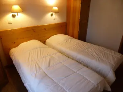 a bedroom with a bed with white sheets and two lights at Résidence Le Grand Panorama - Grand Panorama 115 MAE-5286 in Saint-Gervais-les-Bains