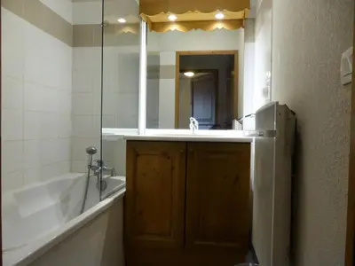 a bathroom with a tub and a sink and a mirror at Résidence Le Grand Panorama - Grand Panorama 115 MAE-5286 in Saint-Gervais-les-Bains