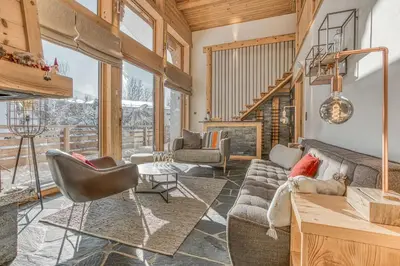 a living room with a couch and a table at Chalet Nepal in Megève