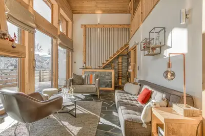 a living room with a couch and a table at Chalet Nepal in Megève
