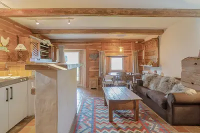 a living room with a couch and a table at Chalet Ontario in Demi-Quartier