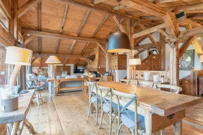 a dining room with a wooden table and chairs at Chalet Ontario in Demi-Quartier