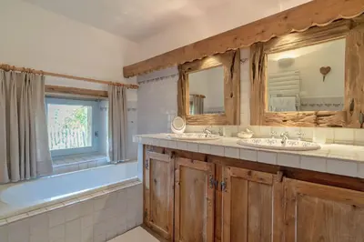a bathroom with two sinks and a large window at Chalet Ontario in Demi-Quartier
