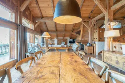 a large wooden table in a room with chairs at Chalet Ontario in Demi-Quartier