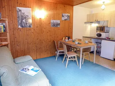 a small room with a table and a kitchen at Studio L'Aiguille du Midi-9 by Interhome in Chamonix-Mont-Blanc
