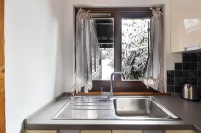 a kitchen with a sink and a window at House Berenice - Chamonix les Praz in Chamonix-Mont-Blanc