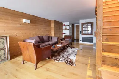 a living room with a leather couch and chairs at House Berenice - Chamonix les Praz in Chamonix-Mont-Blanc