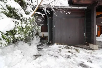 a door to a house in the snow at House Berenice - Chamonix les Praz in Chamonix-Mont-Blanc