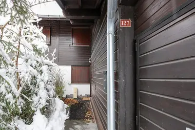 a garage door with a no parking sign on it at House Berenice - Chamonix les Praz in Chamonix-Mont-Blanc