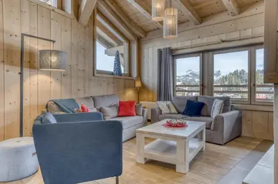 a living room with a couch and a table at Appartement Amour in Megève
