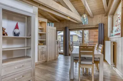 a kitchen with a table and a dining room at Appartement Amour in Megève