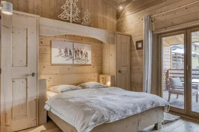 a bedroom in a log cabin with a bed at Appartement Amour in Megève