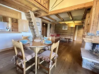 a dining room with a wooden table and chairs at Appartement 3 pièces+cabine à Megève, près des pistes, terrasse, parking, 6 couchages - FR-1-597-1 in Megève