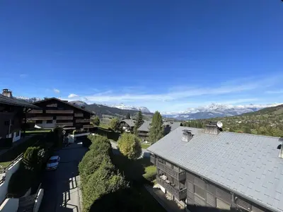 an aerial view of a house with mountains in the background at Appartement 3 pièces+cabine à Megève, près des pistes, terrasse, parking, 6 couchages - FR-1-597-1 in Megève