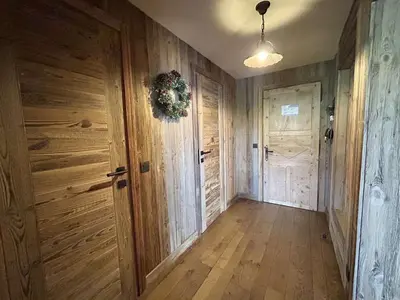 an empty hallway with wooden walls and a door at Appartement 3 pièces+cabine à Megève, près des pistes, terrasse, parking, 6 couchages - FR-1-597-1 in Megève