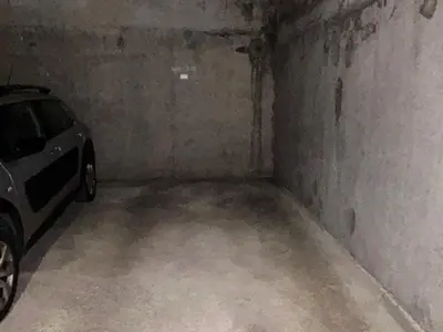 an empty garage with a car parked in it at Appartement 3 pièces+cabine à Megève, près des pistes, terrasse, parking, 6 couchages - FR-1-597-1 in Megève