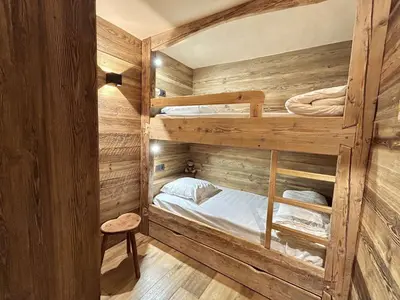 a bedroom with two bunk beds in a wooden room at Appartement 3 pièces+cabine à Megève, près des pistes, terrasse, parking, 6 couchages - FR-1-597-1 in Megève