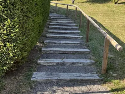 a set of stone steps with a wooden rail at Appartement cosy 2 pièces, 6 couchages, balcon, garage et casier à skis, Demi-Quartier - FR-1-597-9 in Demi-Quartier