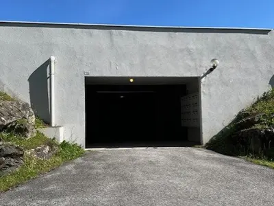 a large garage with a large door in a building at Appartement cosy 2 pièces, 6 couchages, balcon, garage et casier à skis, Demi-Quartier - FR-1-597-9 in Demi-Quartier